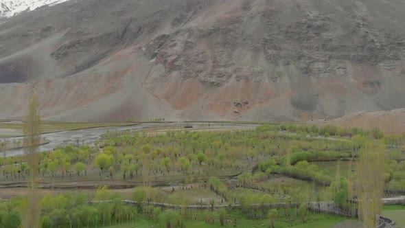 Aerial Over Ghizer Valley Floor With Vegetation In Pakistan. Dolly Forward