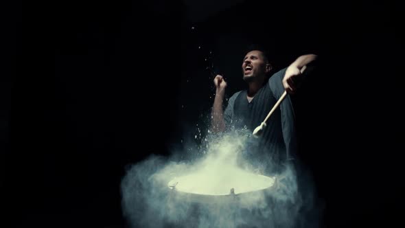 Portrait of a Drummer in Flour on a Black Background