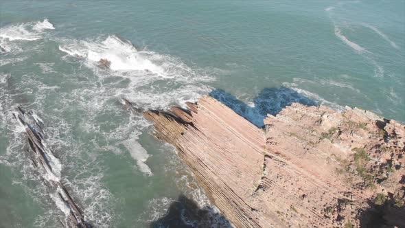 Aerial drone shot of Flysch of Zumaia on a sunny day. (Basque Country, Spain)