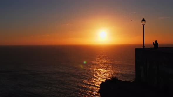 Toutist Enjoys the View From the Miradouro Do Nazare at Sunset