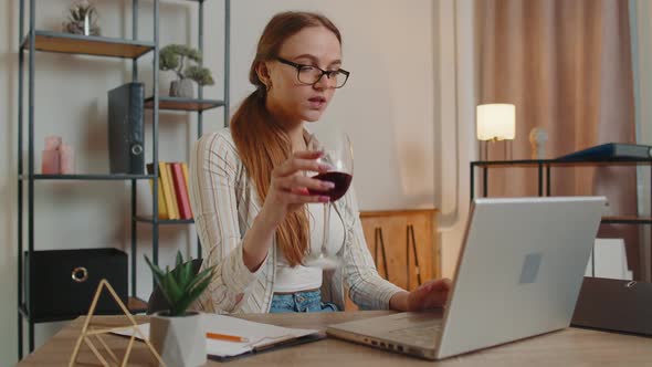 Focused Woman Freelancer Drinking Wine While Working Typing Online on Laptop at Home Distance Office