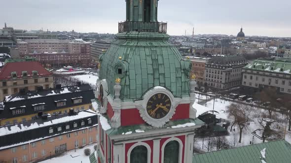Zoom in close up aerial footage of historical clock tower of the St Jacobs Kyrka in the capital of S