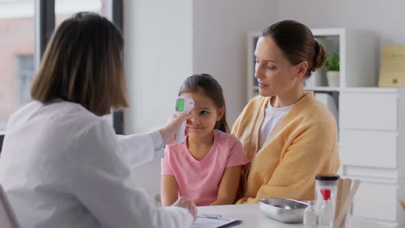 Mother with Sick Daughter and Doctor at Clinic