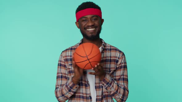 Bearded Smiling African American Young Man Basketball Sport Fan Holding Ball Looking at Camera