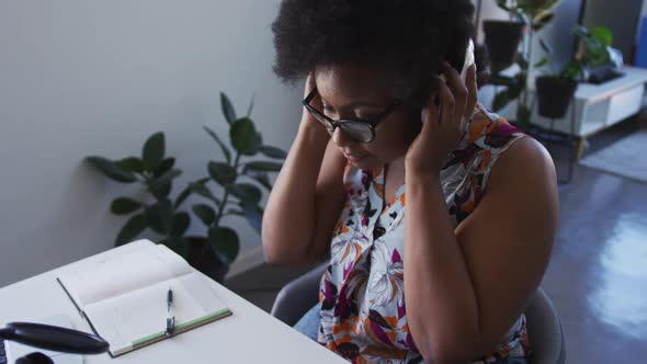 African american female plus size vlogger wearing headphones recording a video blog