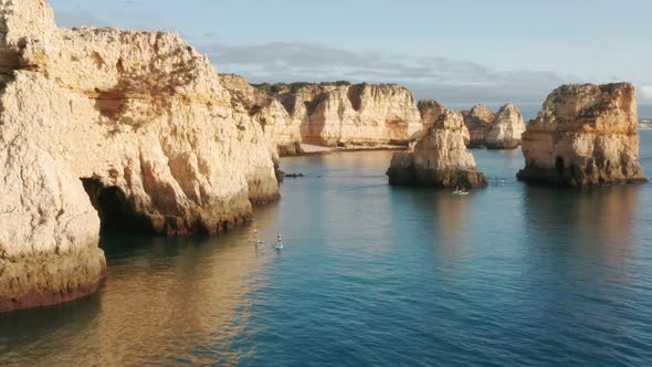 People Using Sup Boards to Travel at Ponta De Piedade Portugal Lagos Europe