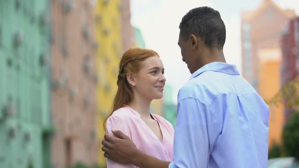 Mixed-Race Teenager Tenderly Stroking Shoulder of Girl Saying Compliments, Date