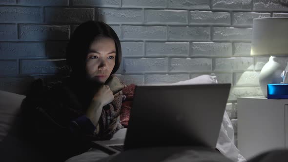 Girl Coughing Hard, Suffering Flu and Insomnia, Watching Film on Laptop at Night