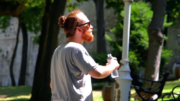 Man Drinking Water In The Park