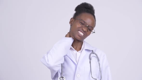 Face of Young Stressed African Woman Doctor with Having Neck Pain