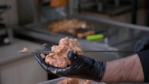 The Chef Sticks Forcemeat on the Skewer and Forming It