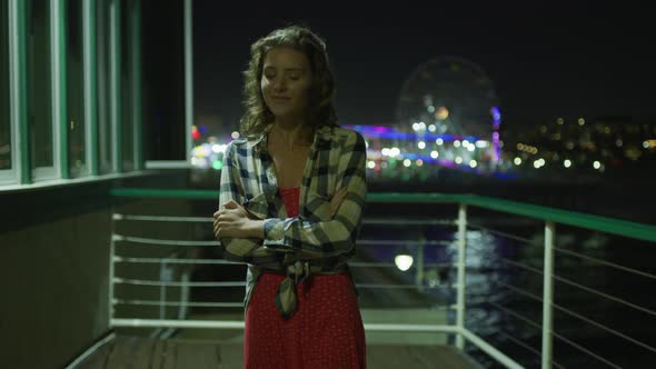 Girl on Santa Monica Pier, at night alt