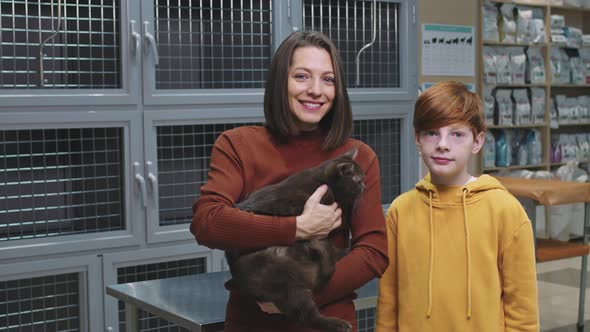 Portrait Of Mom And Son With British Shorthair Cat