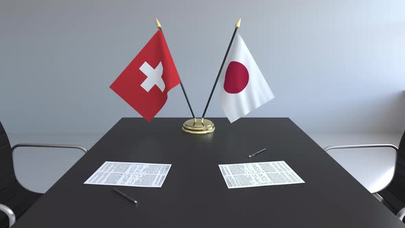 Flags of Switzerland and Japan on the Table