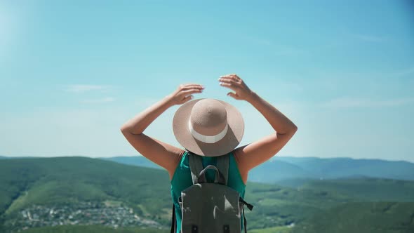 Trendy Backpacker Woman Raising Hand Admiring Nature From Mountain