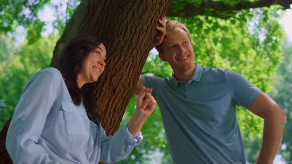 Lovely Couple Talking Lean on Tree Close Up