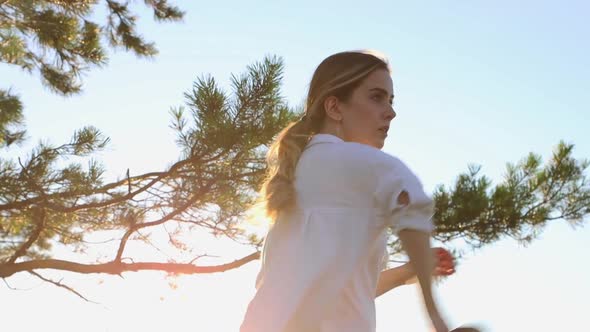 Swords Training Young Pretty Woman in White Shirt Waving with a Sword on Nature at Early Evening on