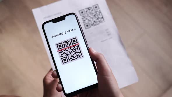 CloseUp POV of Using QR Code Scanner for Pay Online with Money Receipt and QR Code or Barcode Reader