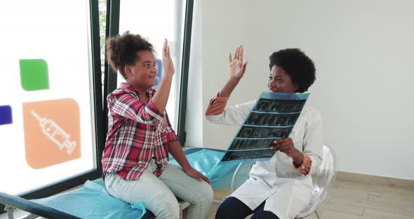 A Pediatrician Doctor And Teenager Greet Each Other With Their Hands