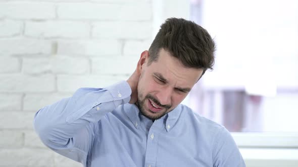 Portrait of Tired Creative Man Having Neck Pain