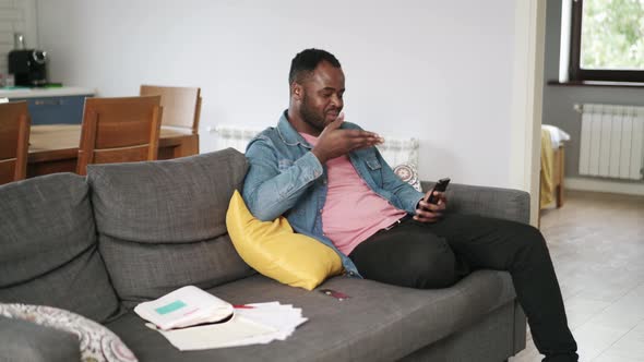 African man talking on video call by phone