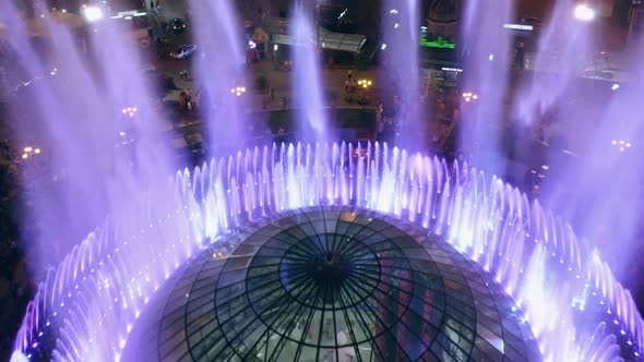 Aerial Top View of Colored Splashing Fountains