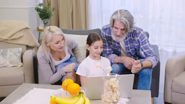 Granddaughter Shows Her Grandparents A Laptop