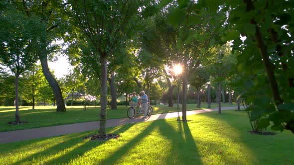 Couple with a Bike Walking