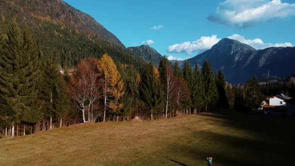 Beautiful Drone Shot of Amazing Autumn Landscape with Tall Mountains Full of Green Forest