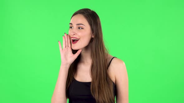 Girl Screams Calling Someone on a Green Screen at Studio