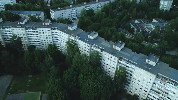 Multi Storey Buildings And A Large Green Area. An Old School Stadium In A City Block.