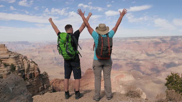 Happy Couple Tourists Celebrate Their Victory At Top Of Grand Canyon Mountain