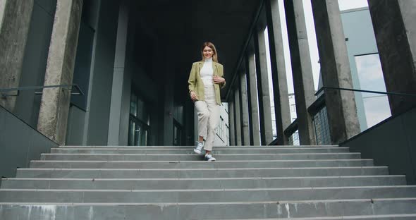 Happy Playful Young Woman Actively Dancing While Walking Down the Stairs.