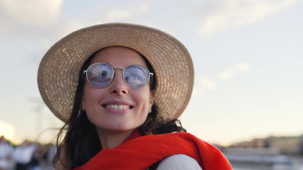 Portrait of smiling tourist woman in summer park