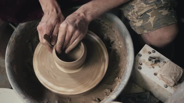 The Hands of a Potter Creating an Earthen Jar on the Circle Closeup Hands on Circle with Clay