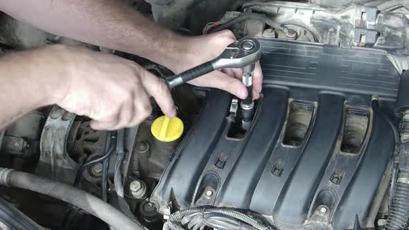 Car Service: Replacement of Spark Plugs.