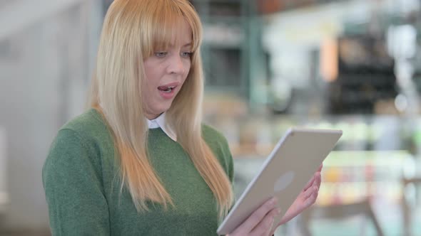 Portrait of Young Woman Having Loss on Tablet in Office