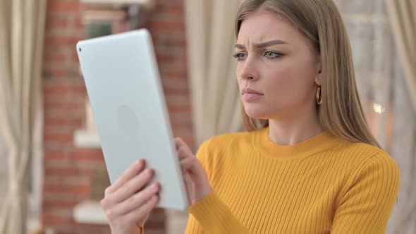 Portrait of Disappointed Young Woman Reacting to Loss on Tablet