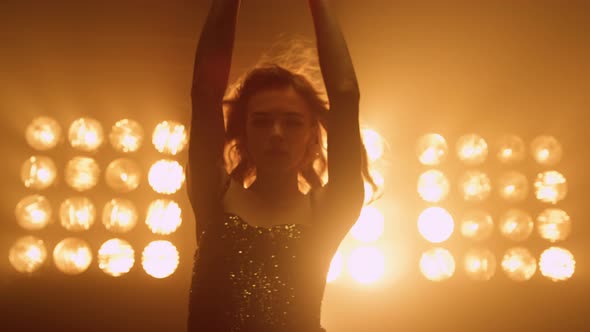 Graceful Woman Dancing Seductive in Studio Lights Close Up