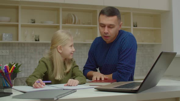 Loving Deaf Father Helping Cute Schoolgirl with Hearing Loss with Homework