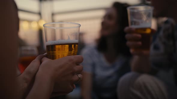 Close up of beer in hand of young man at the party. Shot with RED helium camera in 8K.