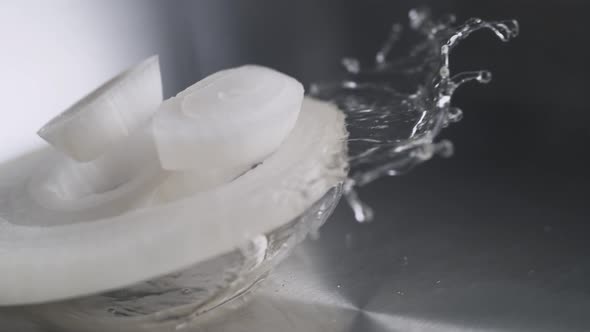 Tossing sliced onion in fry pan. Slow Motion.