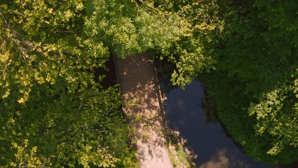 Cyclist Riding Through Field, Drone Shot Of Cyclist Riding Over Bridge