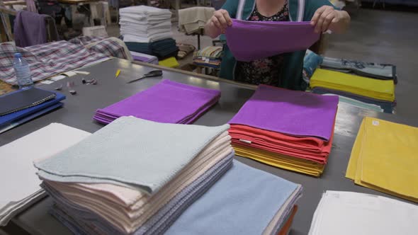 An Employee of a Garment Factory Lays Out Manufactured Products Working Day at the Clothing Factory