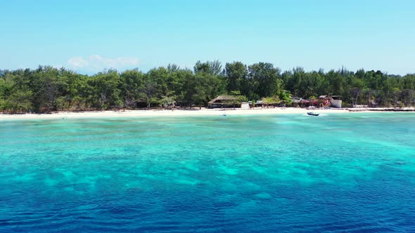 Wide angle fly over travel shot of a sunshine white sandy paradise beach and blue sea background in 