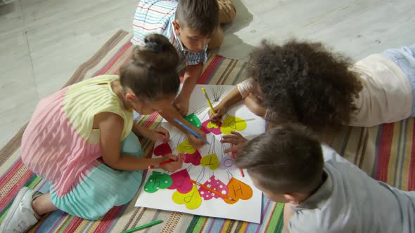 Little Kids Drawing on Handmade Poster in Kindergarten