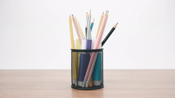 Stop motion animation colored pencils in black transparent stand alt