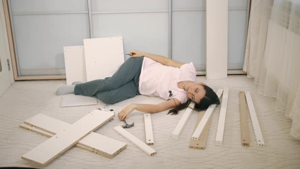 Woman Lies on a Parts of Furniture