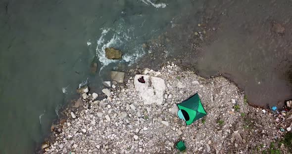 On the Banks of a Mountain River a Fisherman Catches Fish Pitched a Green Tent