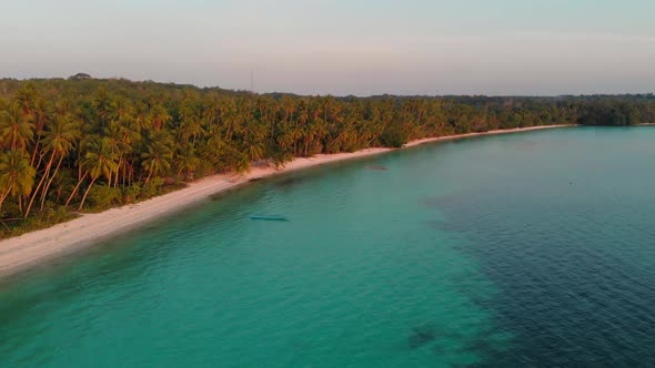 Aerial: uncontaminated white sand beach sunset at Kei Islands Maluku Indonesia